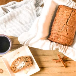 Loaf of banana nut bread, a slice of banana bread with melted butter, and a cup of black coffee