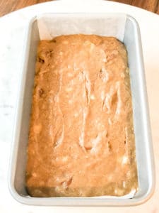 Banana bread batter in a loaf pan ready to be baked.