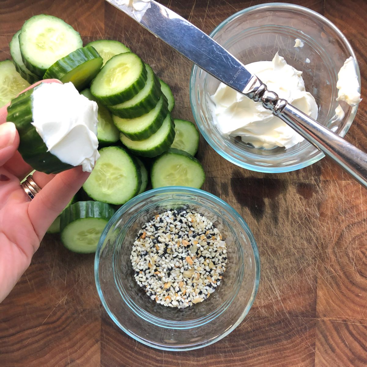 Cucumbers and cream cheese made into mini sandwich with everything bagel seasoning