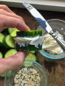 Cucumber slice with cream cheese and seasoning in the background