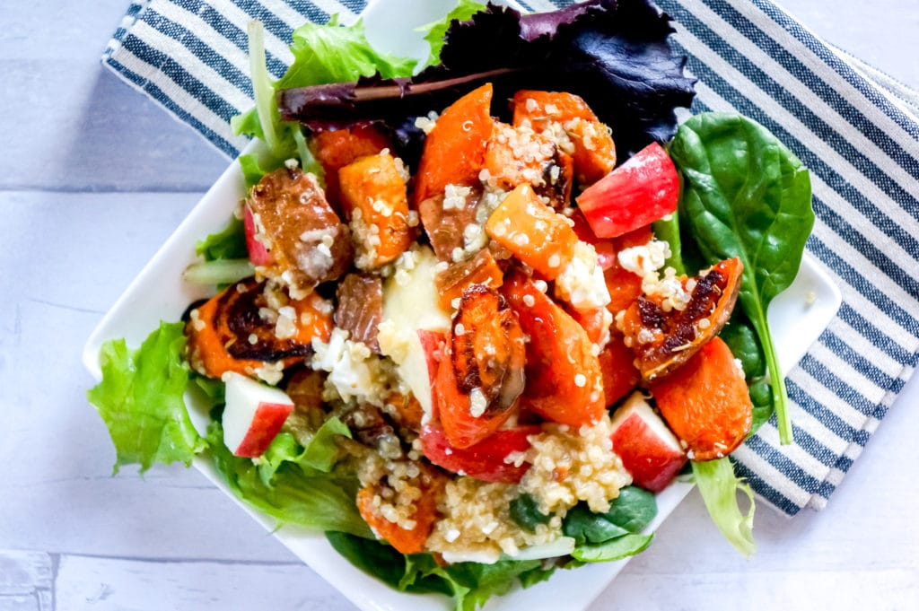 This Harvest Roasted Vegetable and Quinoa Salad with feta cheese and fresh apples recipe is  packed with flavor and healthy whole food ingredients that will leave you feeling satisfied all day. Not only downright delicious eaten warm or cold but, perfect for weeknight dinners or packed up for a picnic lunch at the pumpkin patch. 