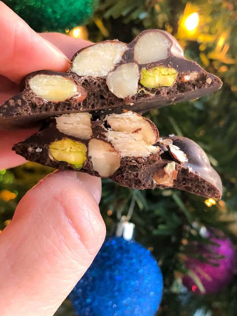 CHOCOLATE NUT CLUSTERS BEING HELD UP