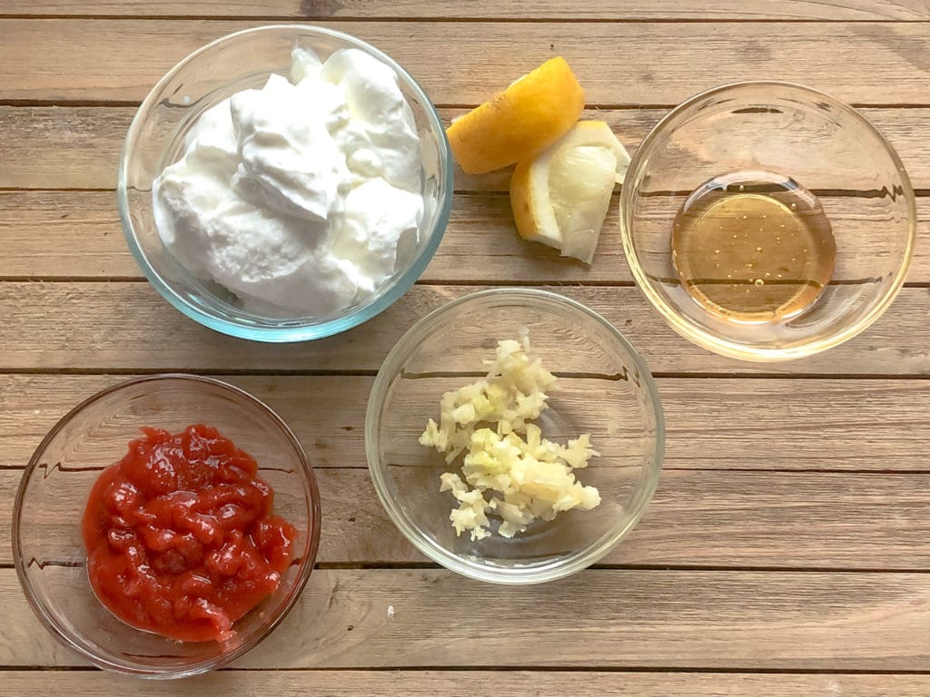 Sriracha aioli ingredients on a wooden board. 