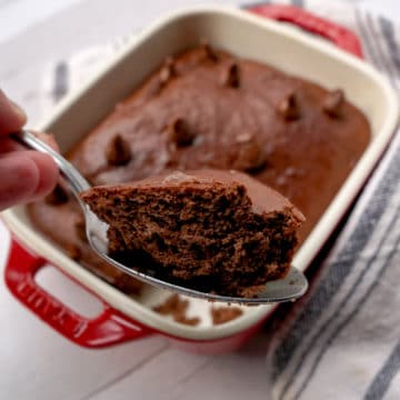 chocolaty brownie begin held up with a spoon.