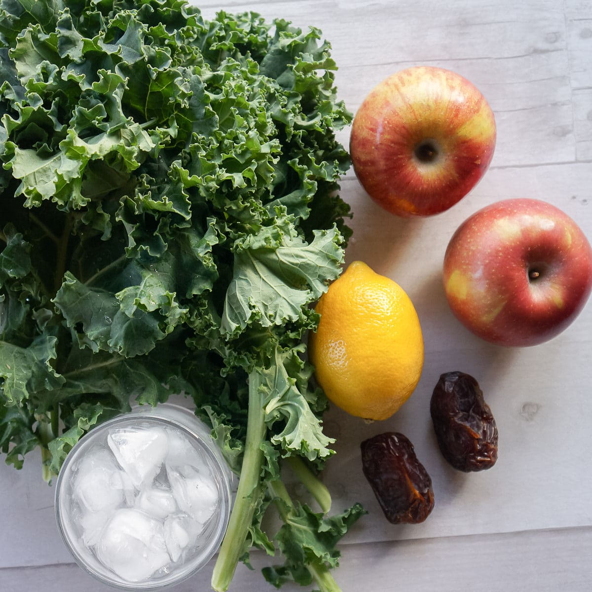 Kale apple smoothie ingredients- fresh kale, fresh apples, dates, lemon, and ice water