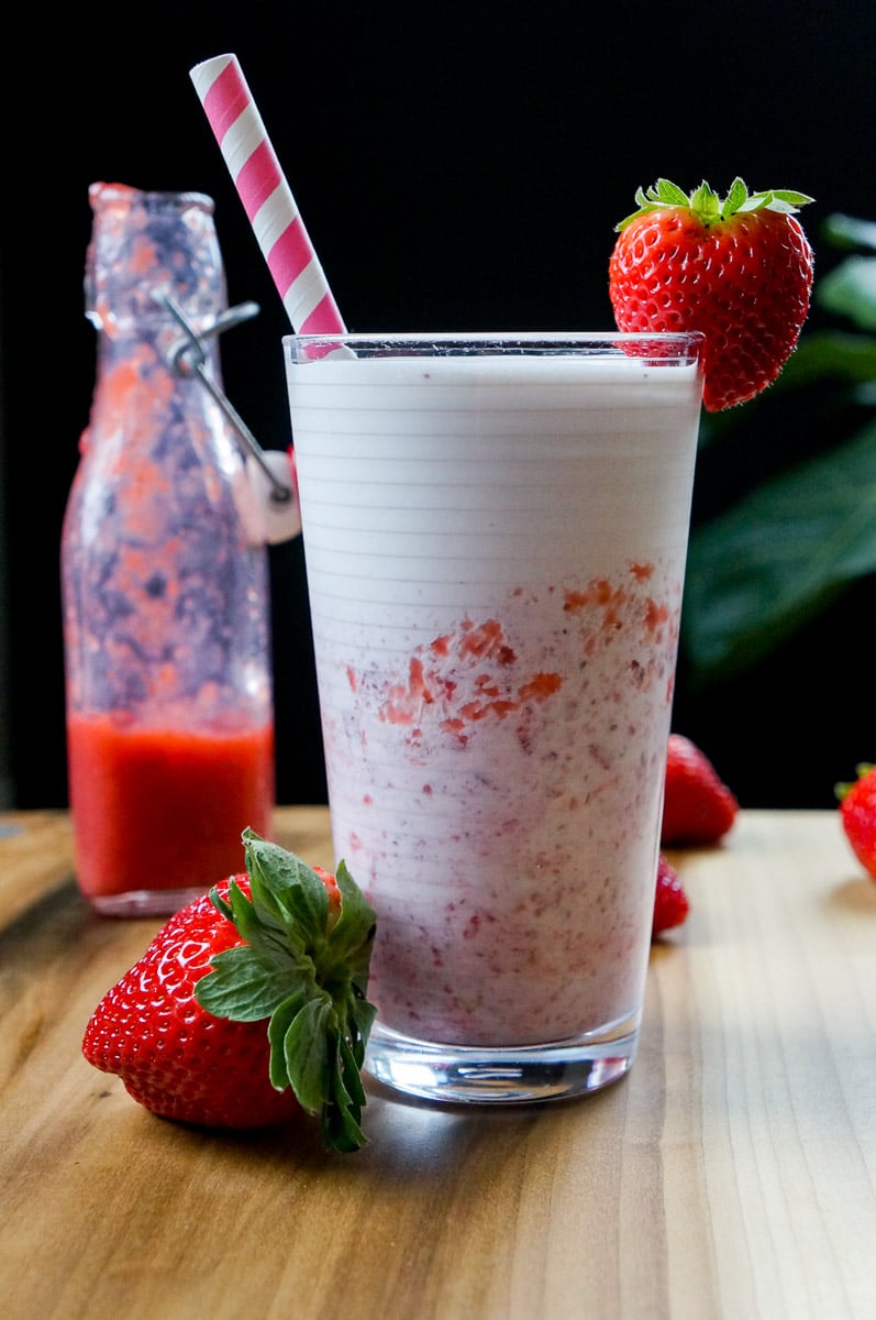 Korean Strawberry Milk in a glass with fresh strawberries