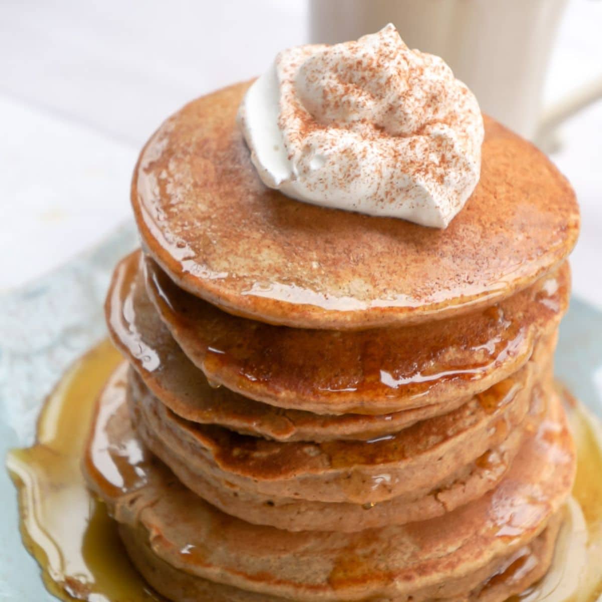 A stack of oat flour pancakes on a plate