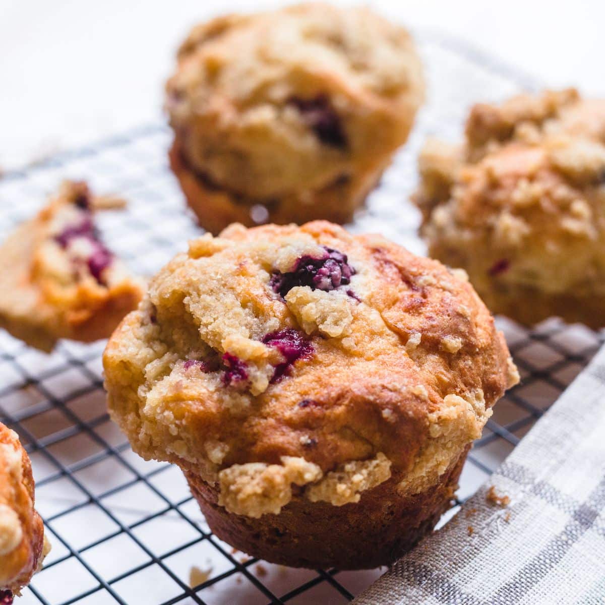 Gluten Free Homemade Banana Blackberry Oatmeal Muffins on a cooling rack.